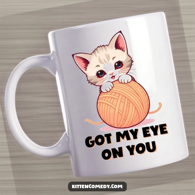 Funny Mug: A playful kitten leaps at a dancing ball of yarn, full of energy and mischief. A delightful scene.