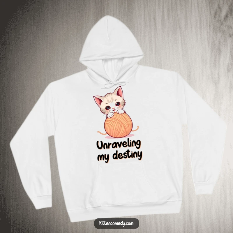 Funny Hoodie: A small kitten hilariously pounces on a dancing ball of yarn. Soft, warm, and full of fun.