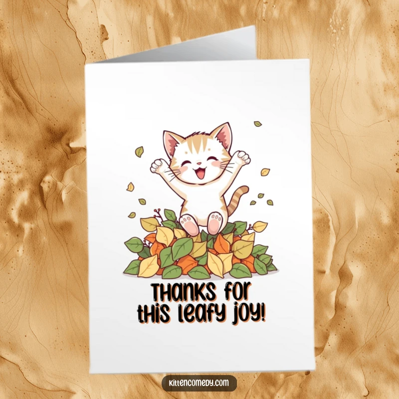 Funny Free Printable Thank You Card: A kitten leaping with joy into a pile of autumn leaves, expressing thanks.