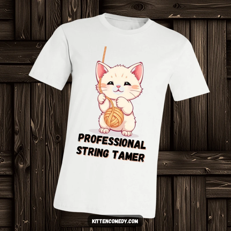 Funny kawaii kitten t-shirt batting at a dangling yarn ball, showcasing its energetic and playful personality.