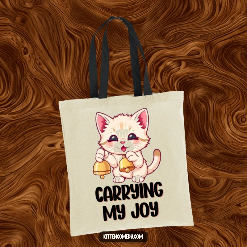 Funny Kawaii Kitten Tote Bag: A cute kitten eagerly pawing at a dangling bell with eyes full of joy.