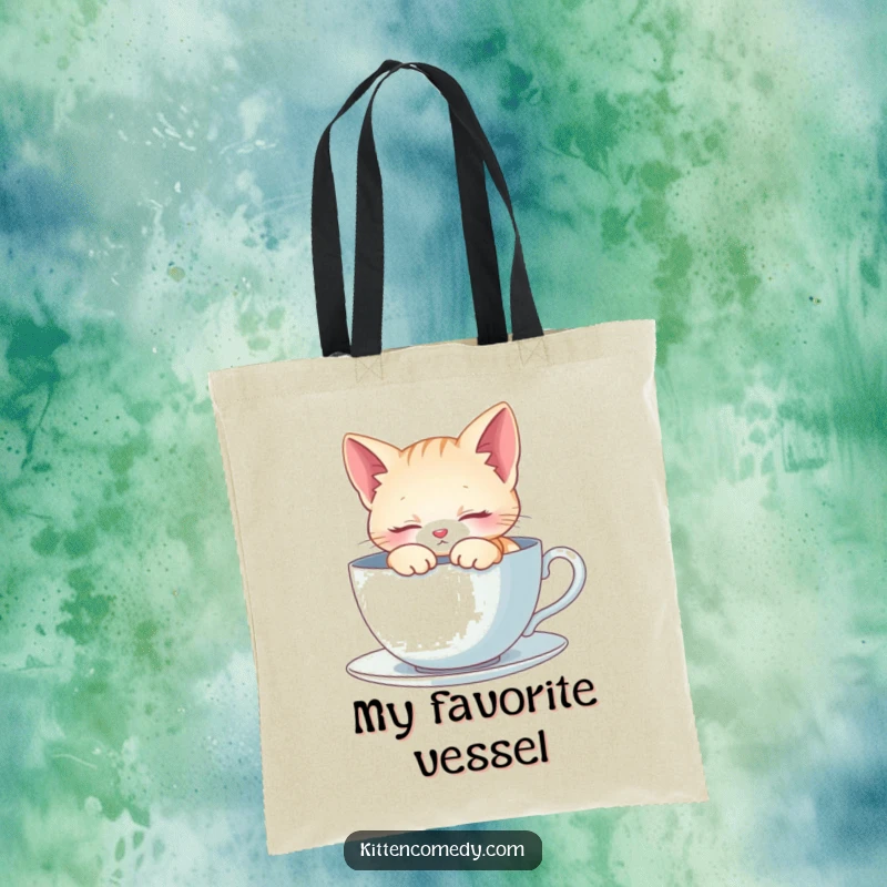 Funny Tote Bag: A kitten sleeps peacefully inside a large teacup. Ideal for carrying relaxation and essentials.